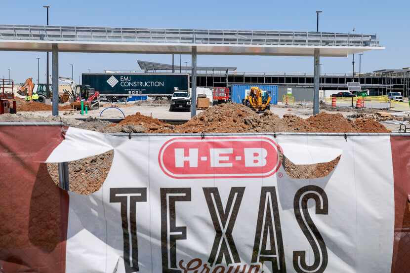 Construction fence signs like this one photographed in April at the Frisco H-E-B store will...