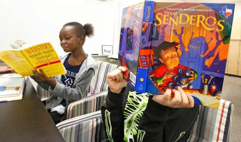 
Fourth-graders, including Mariam Jalloh (left) study language at Hackberry Elementary...