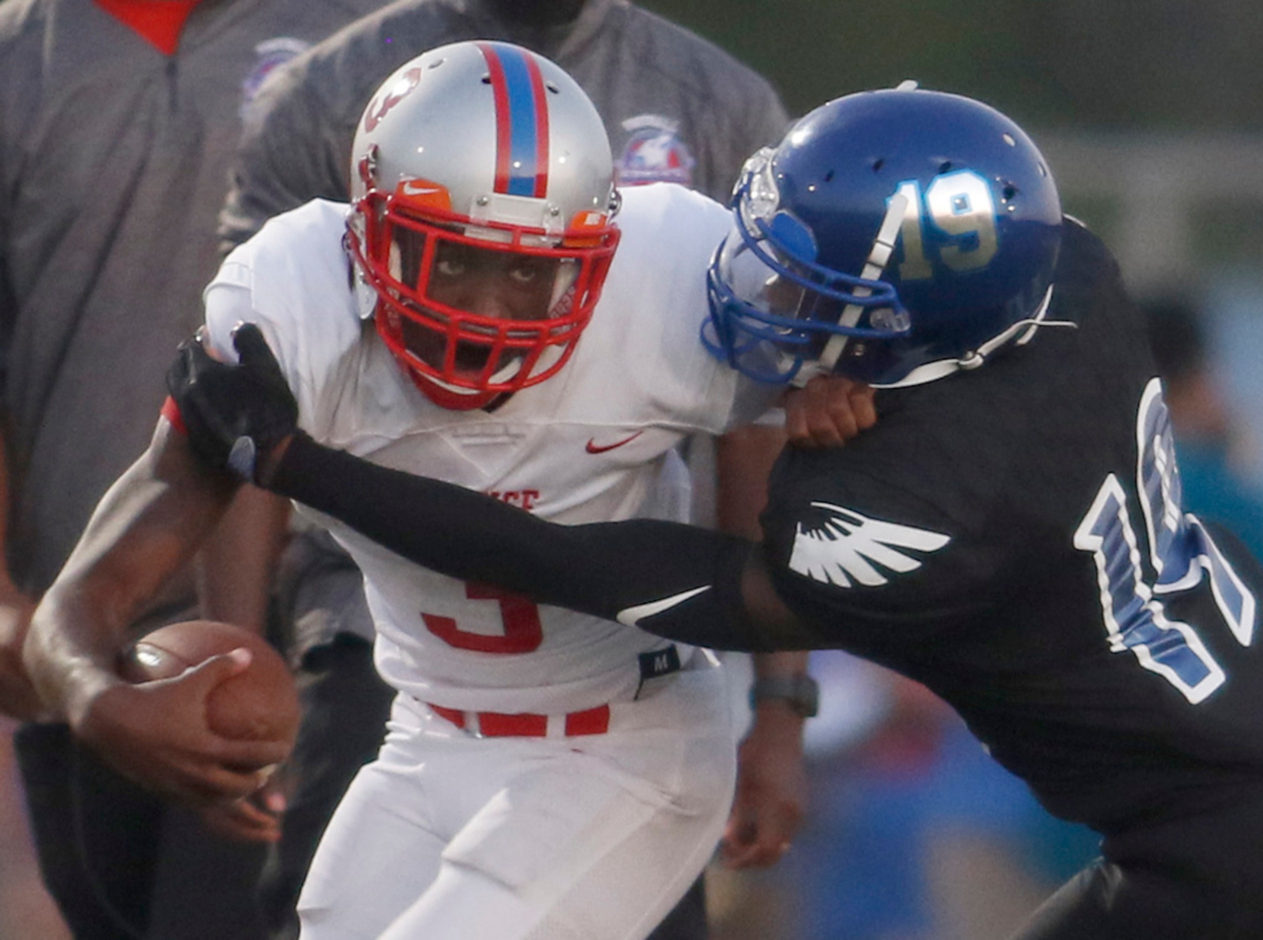 Spruce receiver Mardio Trigg (3) is wrapped up defensively by Wilmer Hutchins defensive back...