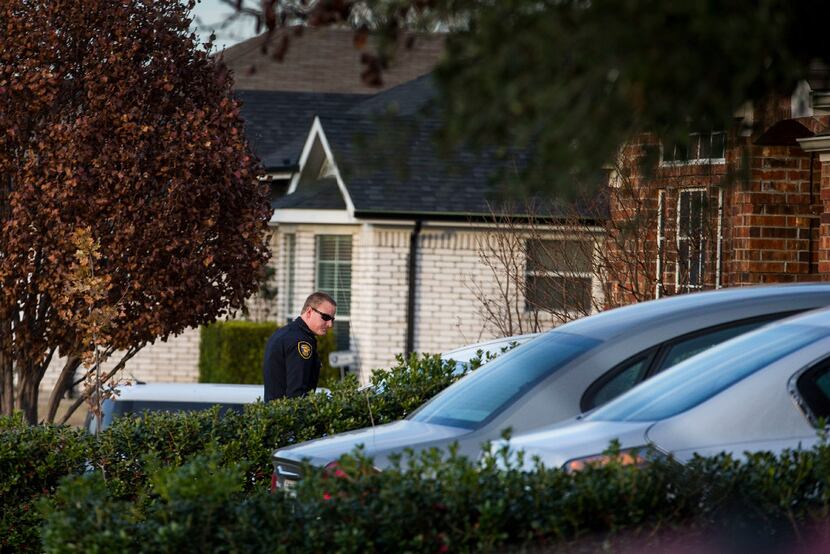 A Fort Worth police officer approaches the house of a neighbor whom Jacqueline Craig accused...
