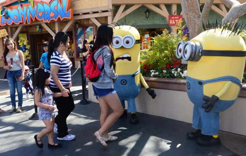 
People dressed as Minions attract visitors at Universal Studios where the Despicable Me...