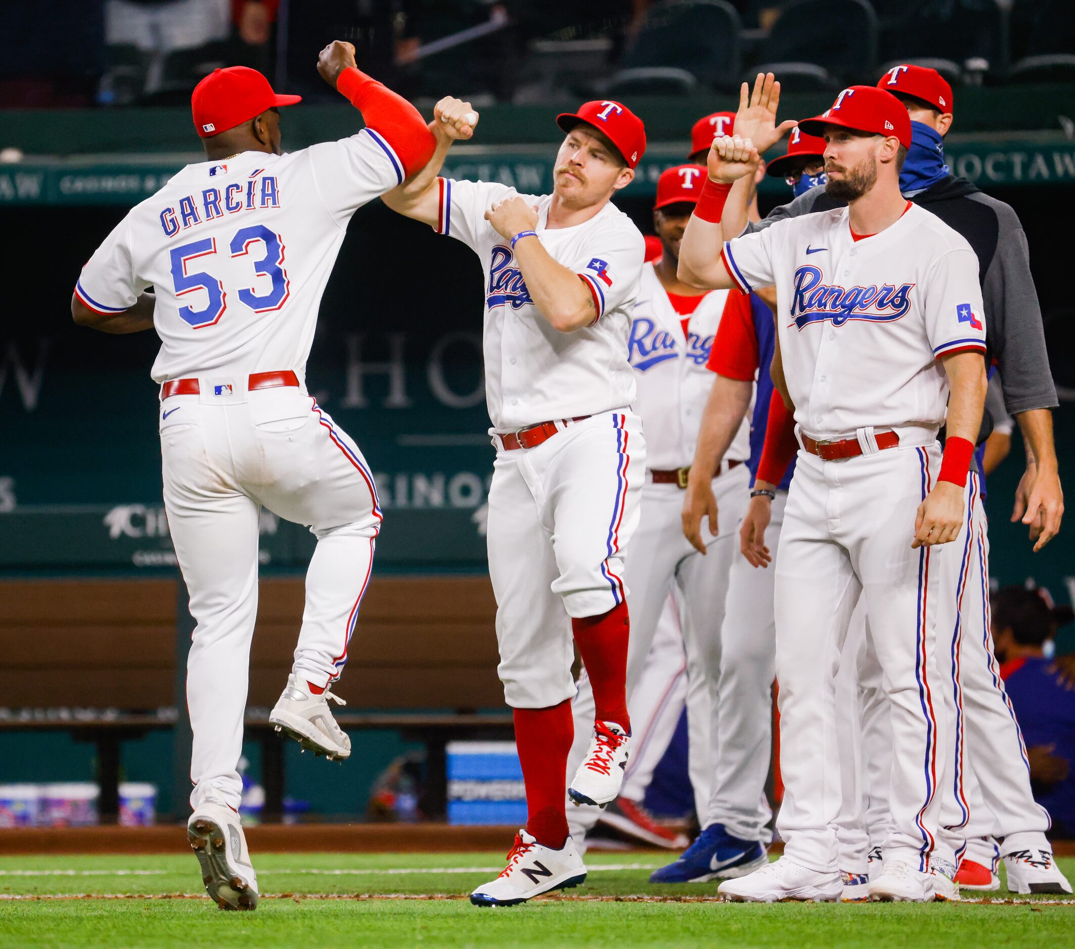 The Texas Rangers celebrate defeating the Los Angeles Angels at Globe Life Field on Tuesday,...