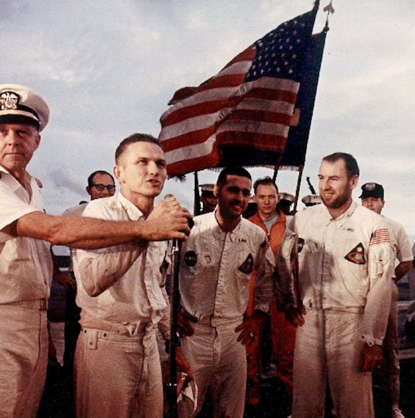 Apollo 8 Spacecraft commander Frank Borman addresses the crew of the USS Yorktown alongside...