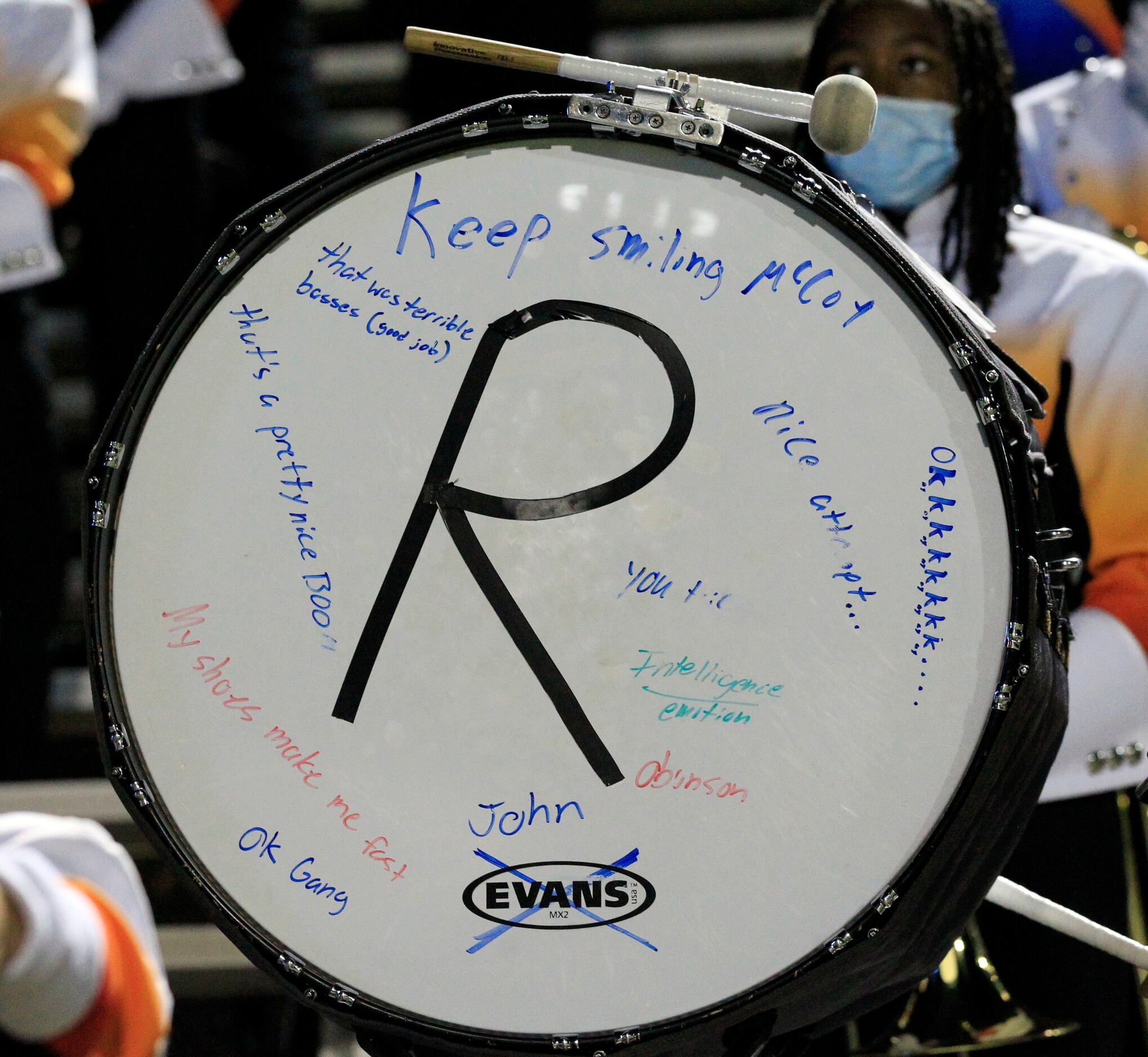 A Sachse band drum is covered with comments at a high school football playoff game between...