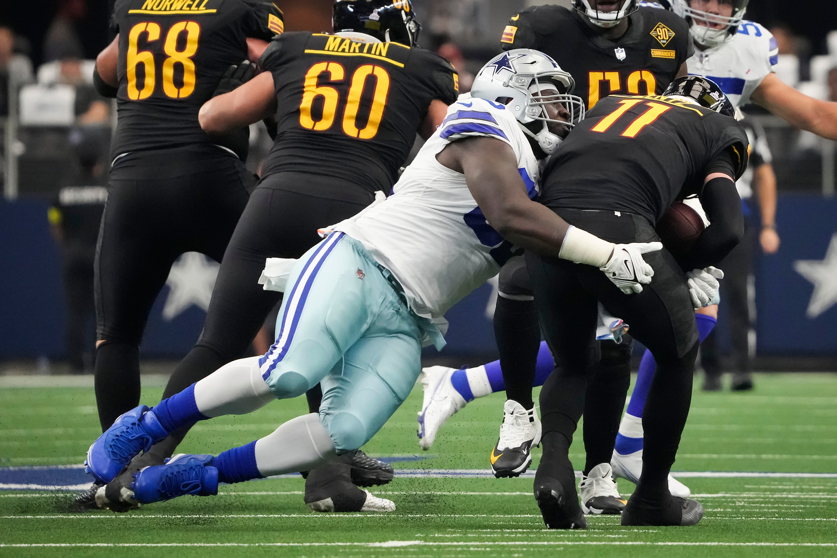 Dallas Cowboys defensive tackle Neville Gallimore (96) sacks Washington Commanders...