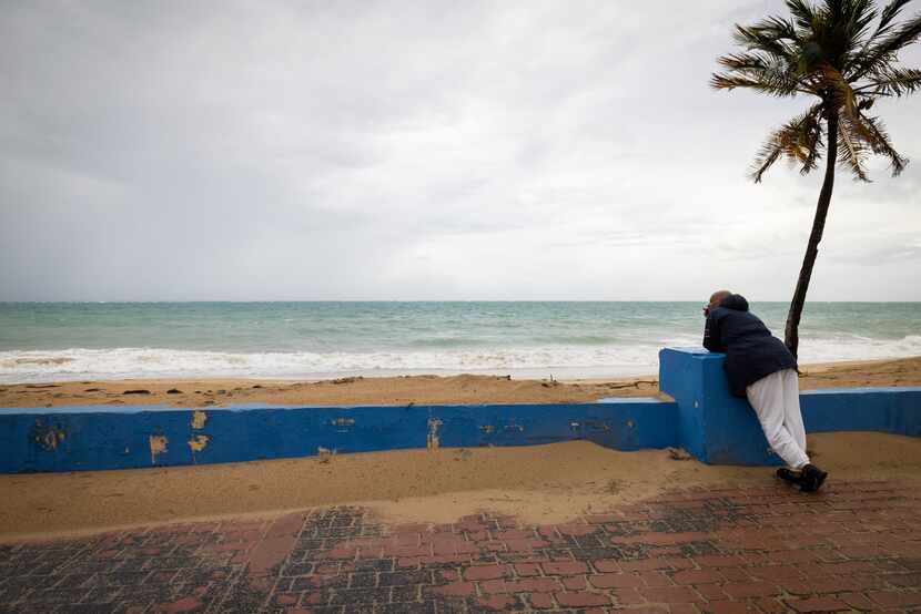 A man stands near a beach before the arrival of Tropical Storm Fiona in San Juan, Puerto...