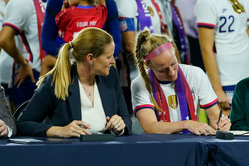 Cindy Parlow Cone, left, president of the U.S. Soccer Federation, looks on as United States'...