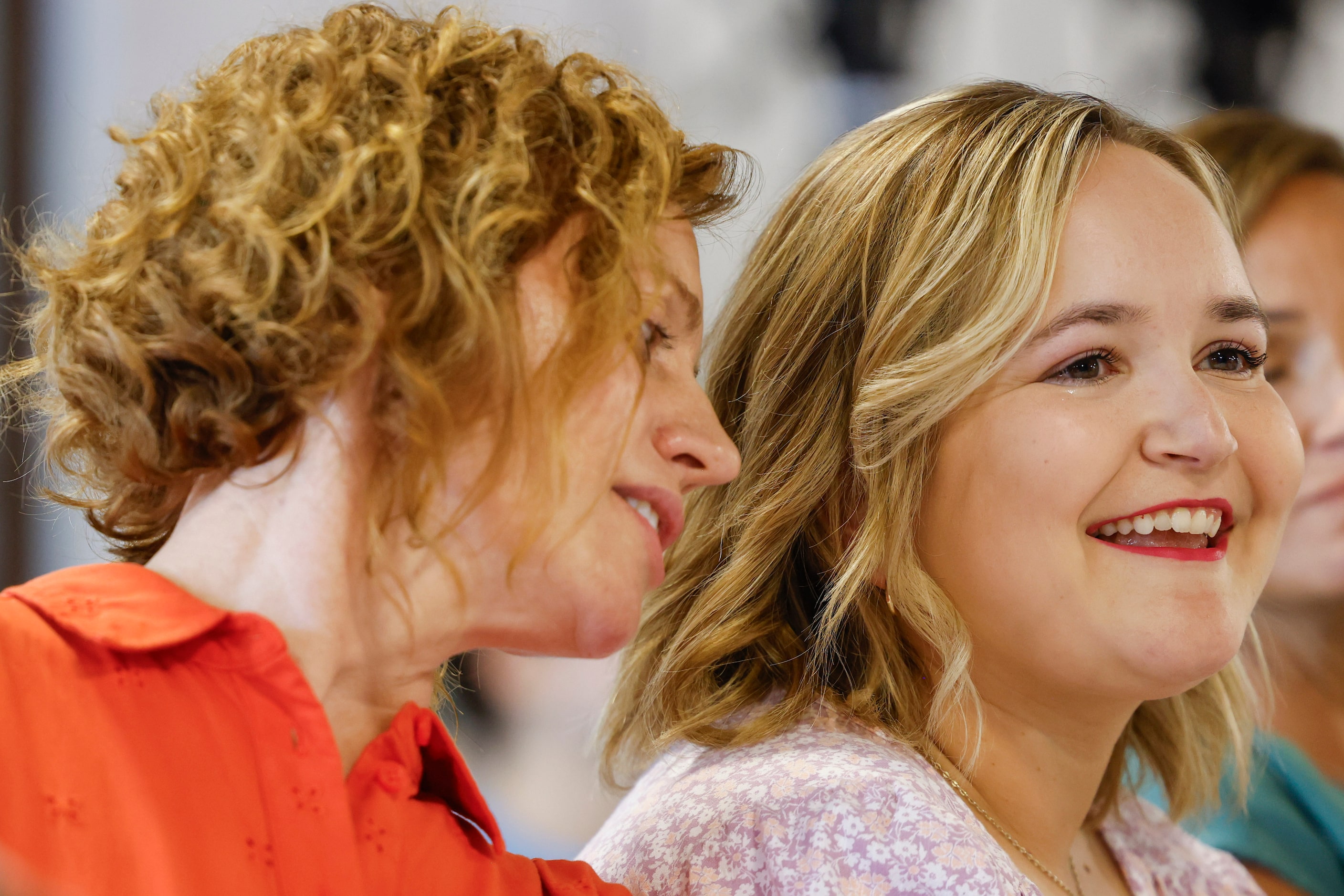 Puppy raiser Michaela Durisek (left) talks to Lauren  Anderson while watching a video...