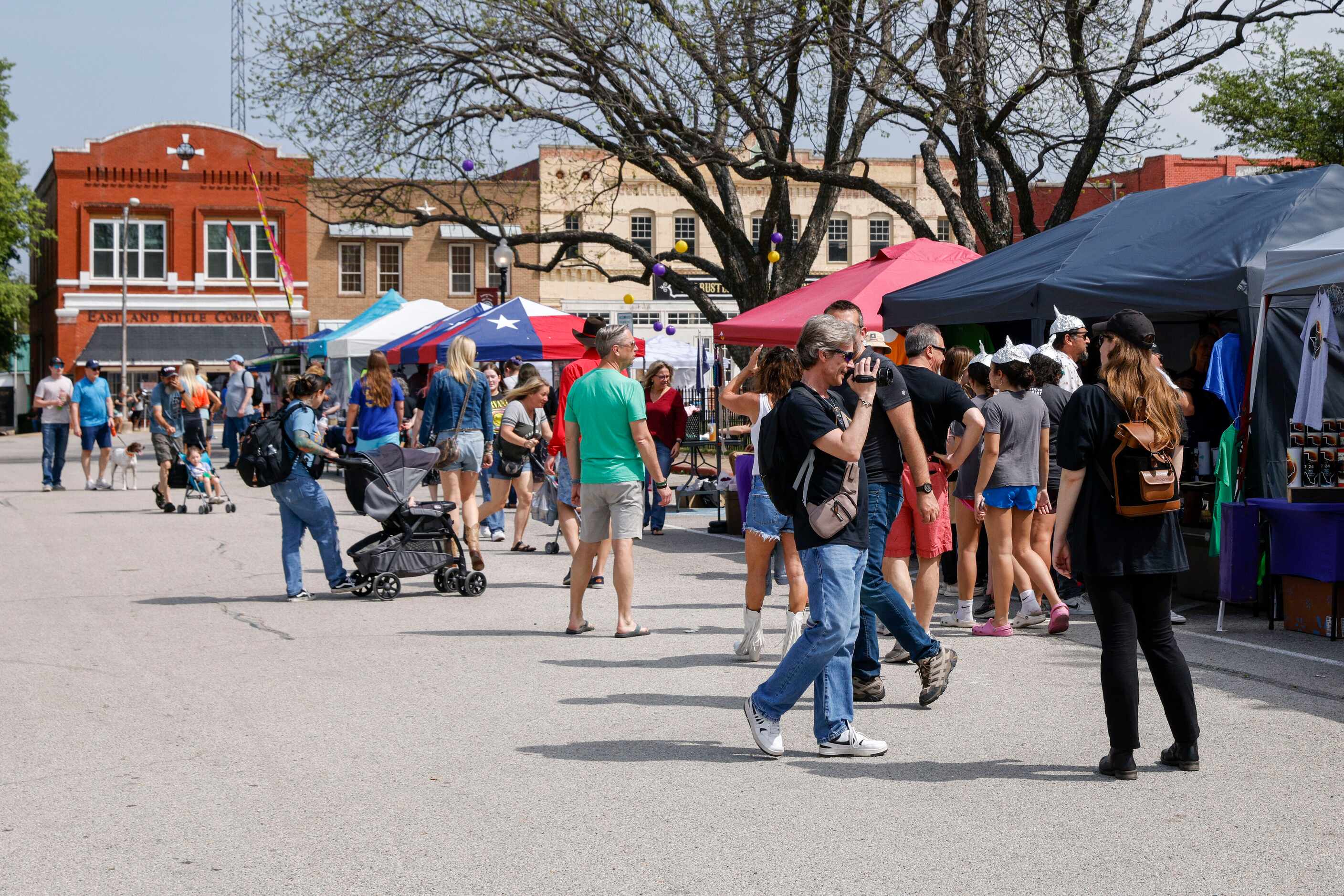 People visit various vendors in the Hillsboro square before a total solar eclipse, Monday,...