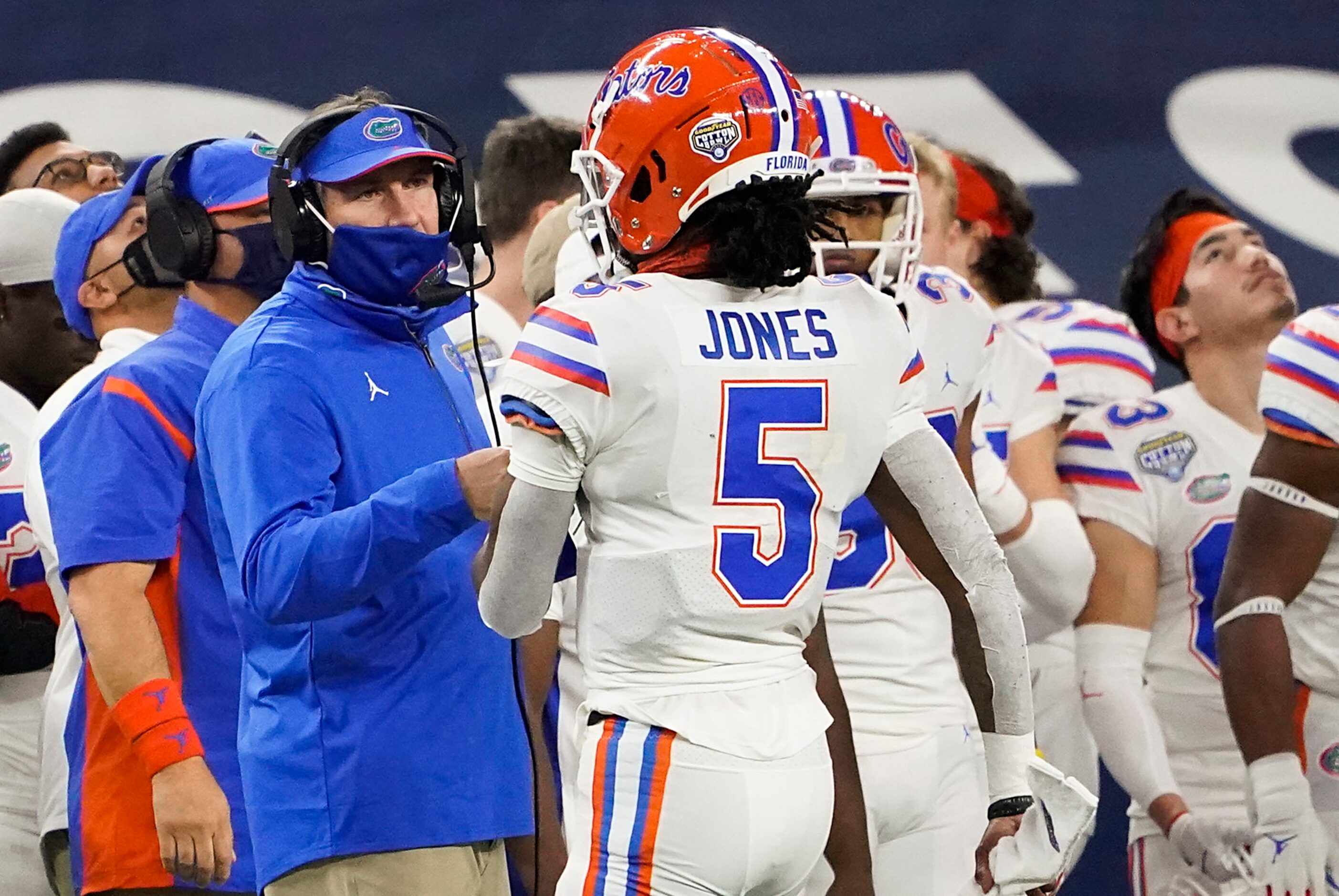 Florida head coach Dan Mullen talks with quarterback Emory Jones (5) on the sidelines during...