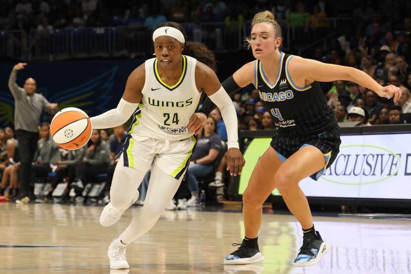 Dallas Wings guard Arike Ogunbowale (24) drives around the defense of Chicago Sky guard...