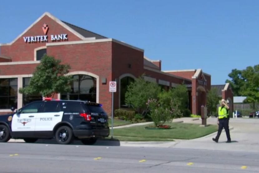 Police presence outside Veritex bank Thursday morning, where officials say three bank...