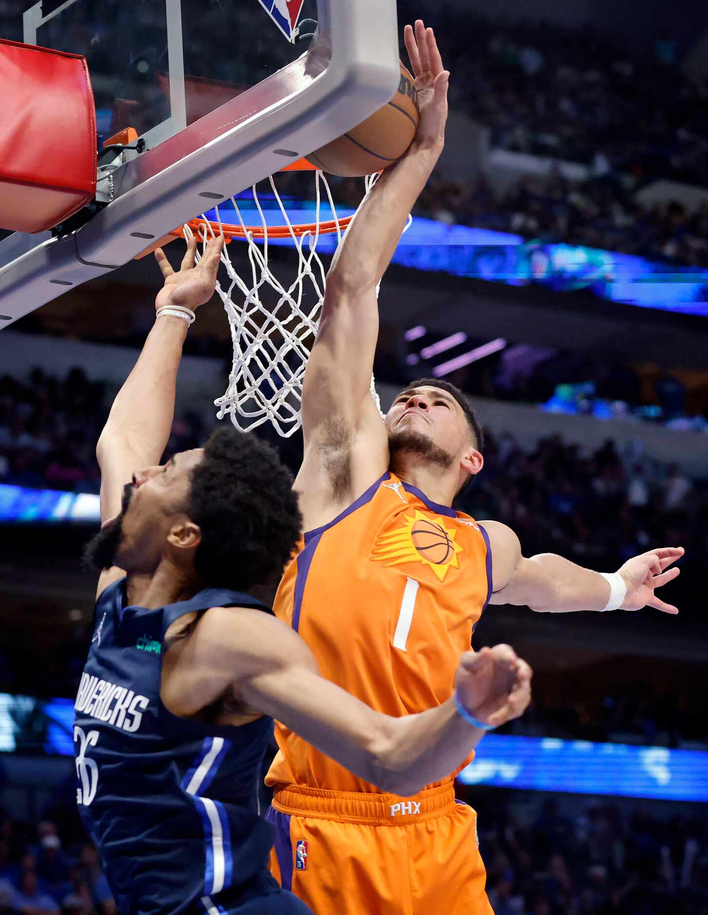 Phoenix Suns guard Devin Booker (1) blocks a shot by Dallas Mavericks guard Spencer...