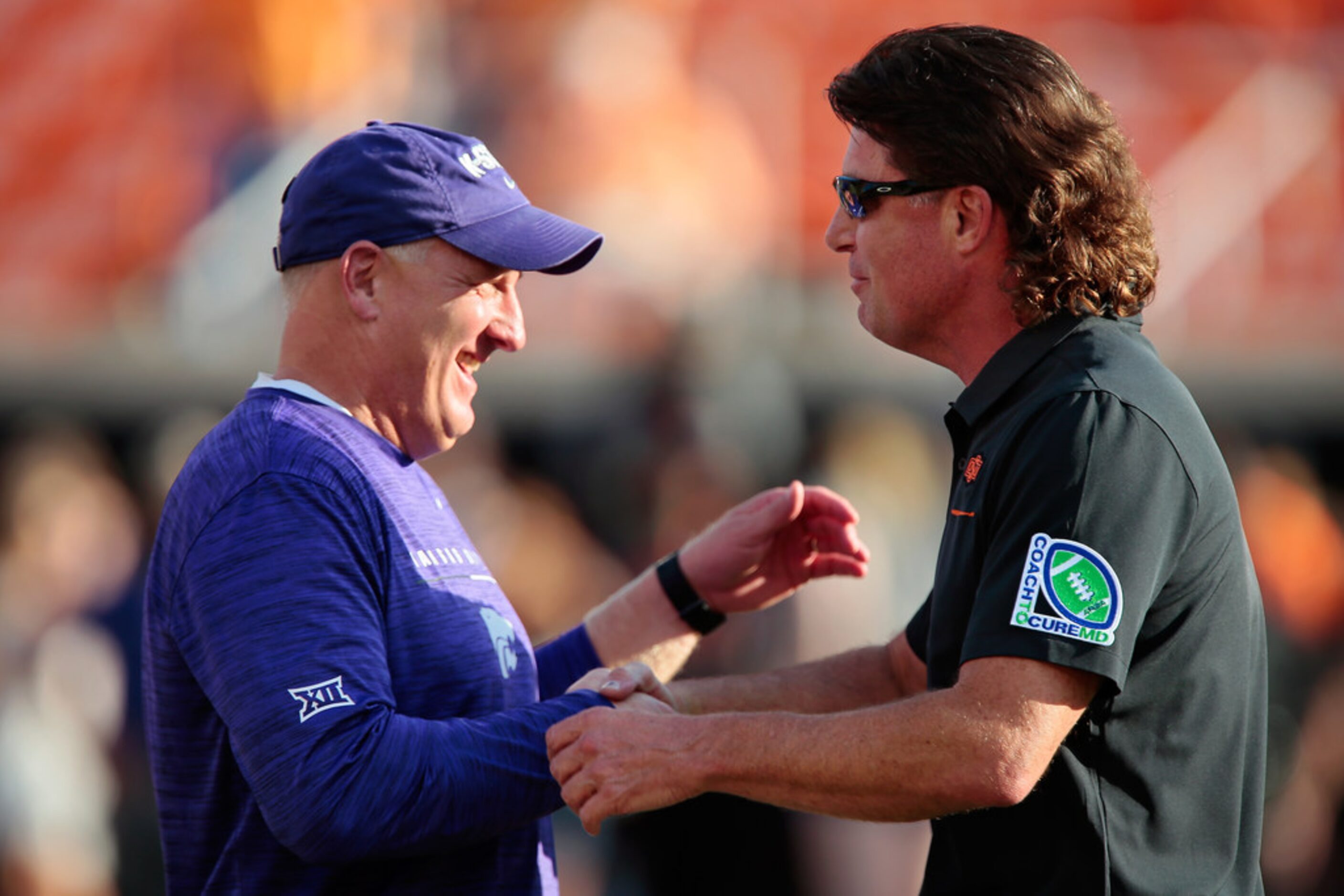 STILLWATER, OK - SEPTEMBER 28:  Head coach Mike Gundy of the Oklahoma State Cowboys greets...