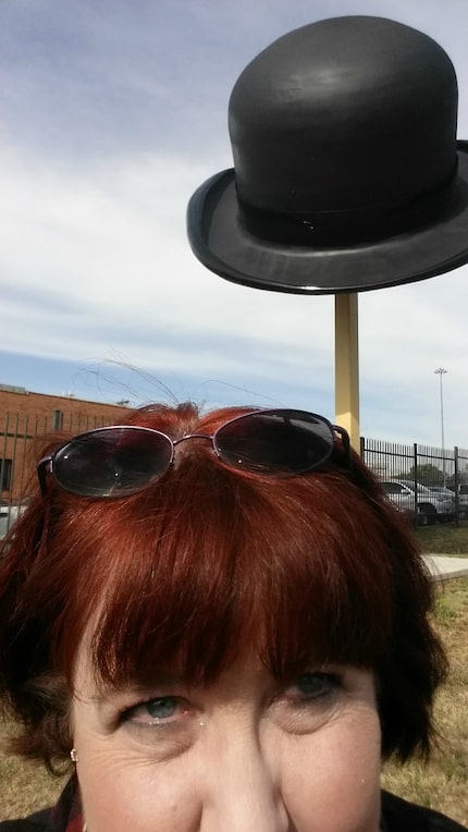 Joy Tipping in front of the giant bowler hat in the Southside area south of downtown Dallas. 