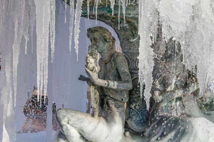 Icicles hang from a fountain at the The Village at Sports Center shopping center in Arlington.