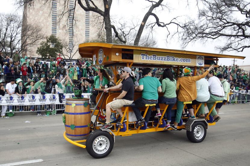 The buzz bike makes its way down the street during the 35th Anniversary Dallas St. Patrick's...
