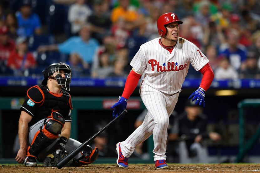 Philadelphia Phillies' Asdrubal Cabrera, right, watches the ball after hitting a double off...