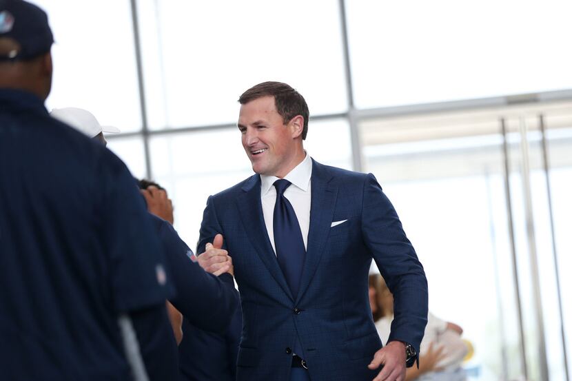 Dallas Cowboys tight end Jason Witten is greeted by players and coaches walking into a news...