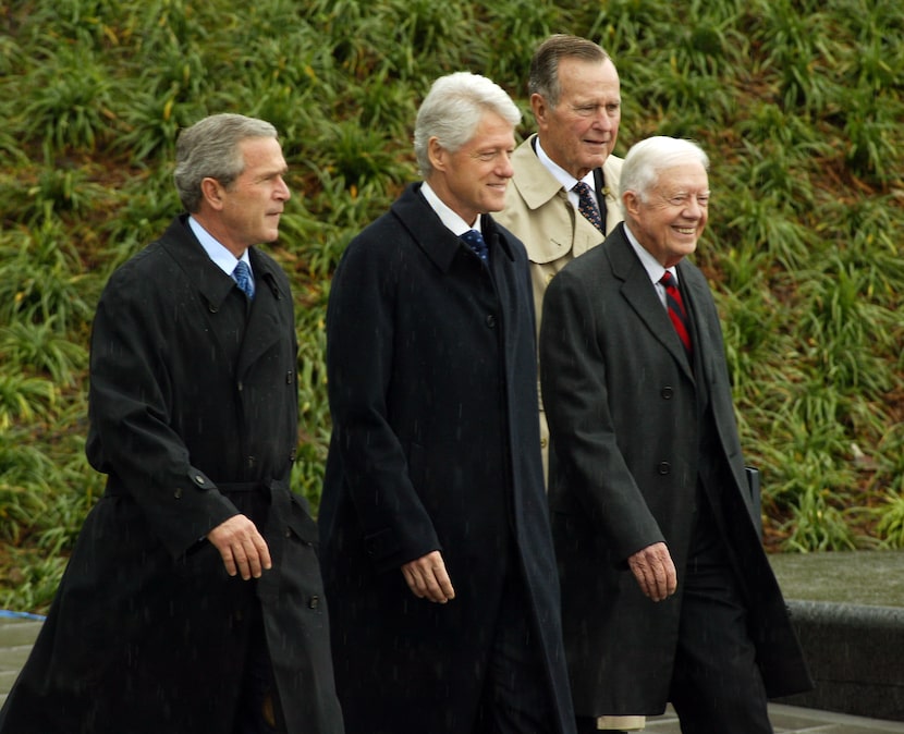 Then-President George W. Bush and former presidents Bill Clinton, Jimmy Carter and George...