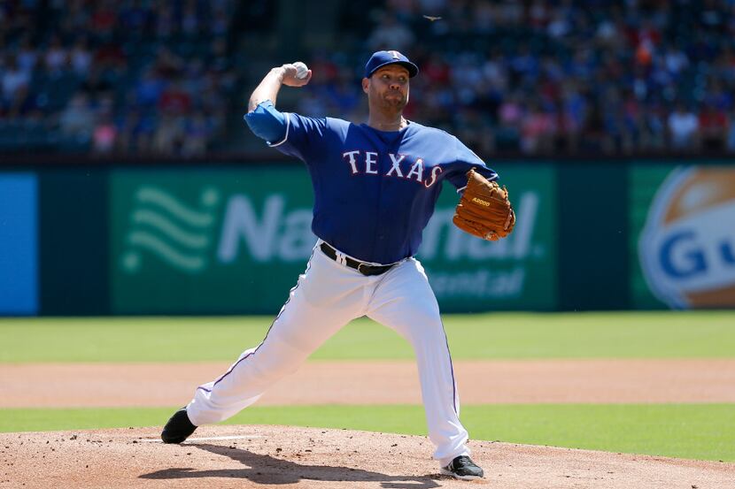 Texas Rangers starting pitcher Colby Lewis works against the Oakland Athletics in the first...