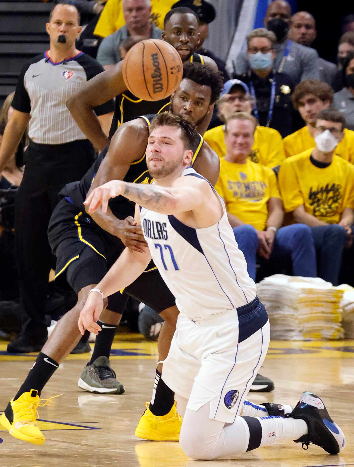 Dallas Mavericks guard Luka Doncic (77) passes the ball after going to the floor for a loose...