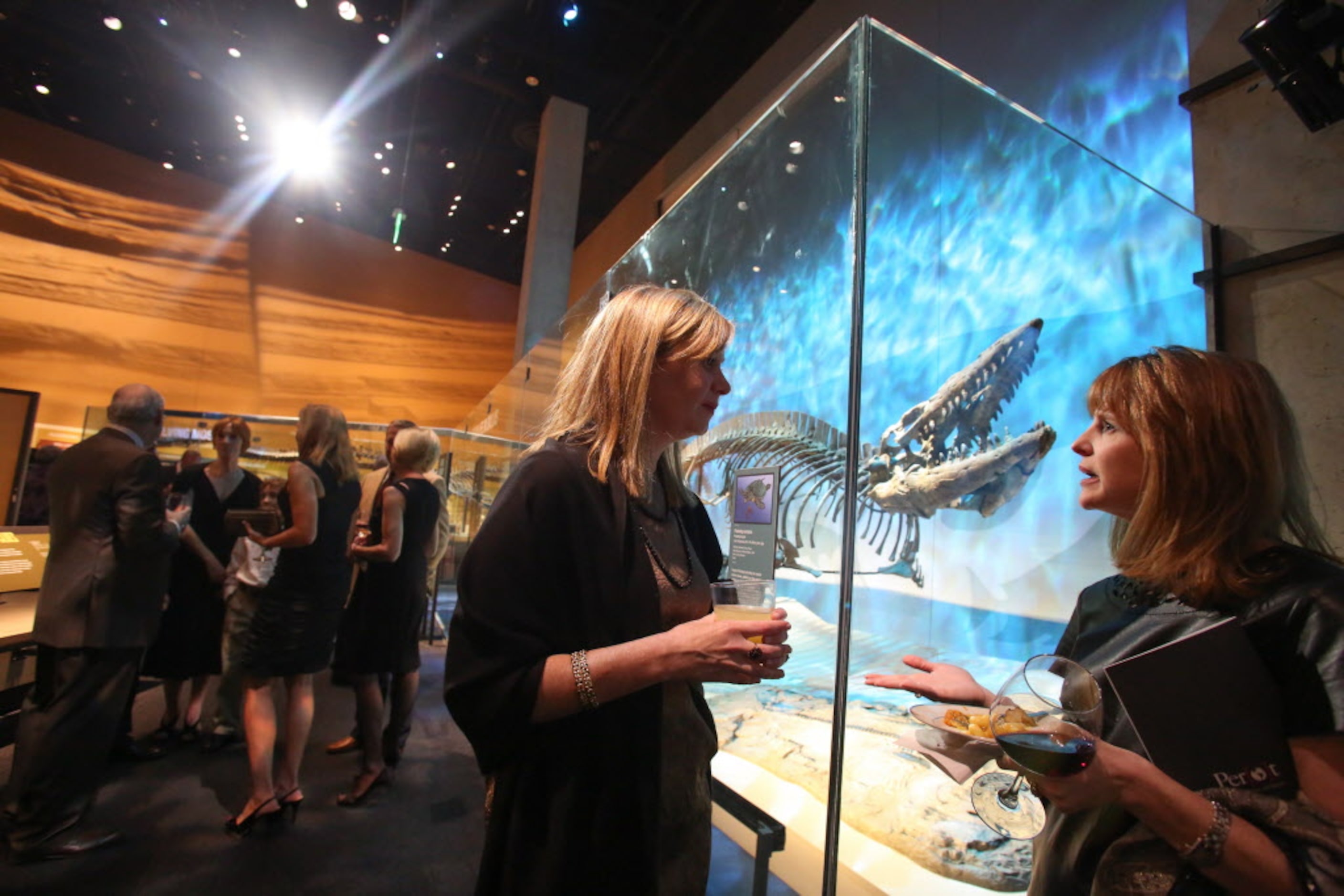 Katie Botik, of Dallas, and Monica Smith, of Dallas, mingled next to the Protostega skeleton...