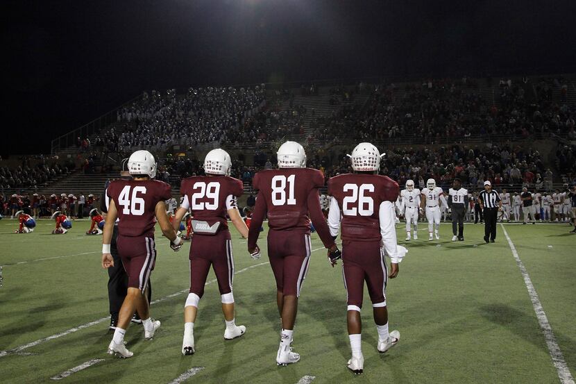 Captains meet at midfield before kickoff as Plano Senior High School hosted Allen High...