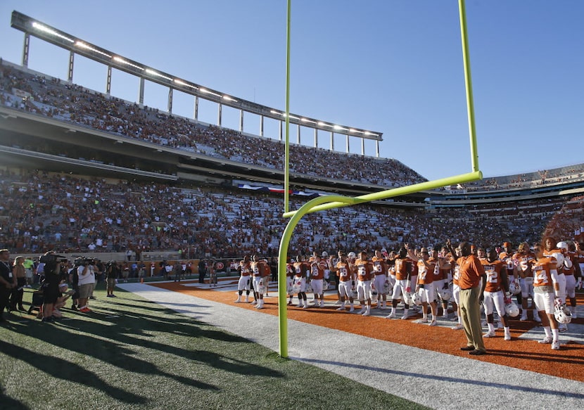 The Texas Longhorns stand in the end zone for the "Eyes of Texas" rendition before going to...