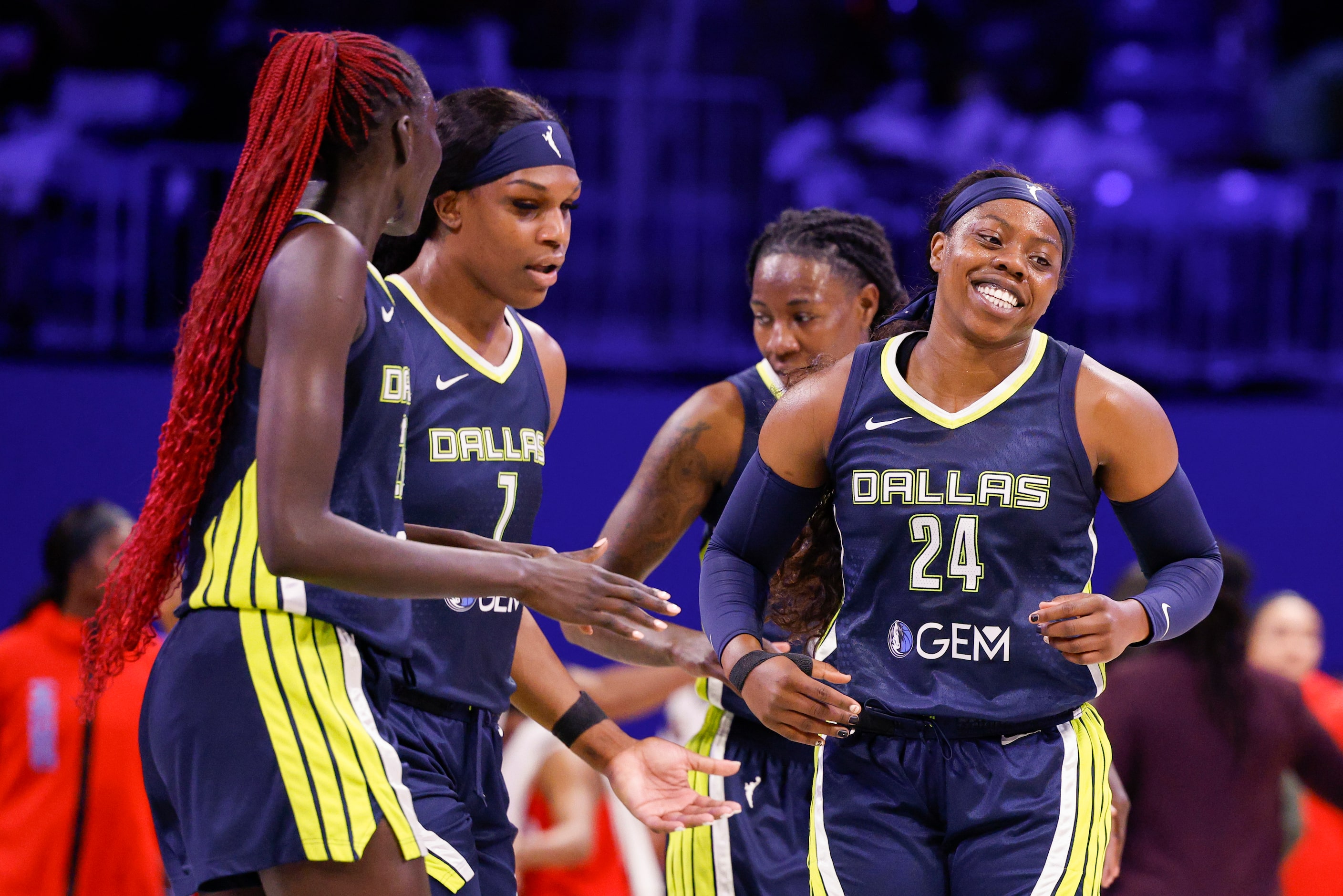 Dallas Wings guard Arike Ogunbowale (24) celebrates after making a basket with teammates...