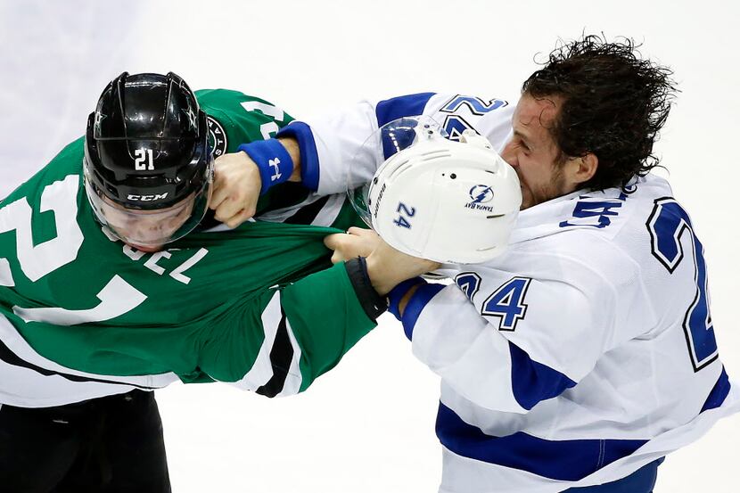 Dallas Stars left wing Antoine Roussel (21) fights with Tampa Bay Lightning right wing Ryan...