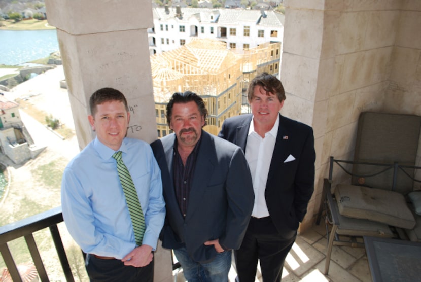 Michael Quint (left), George Fuller and Jeff Blackard stand in the Adriatica Village bell...