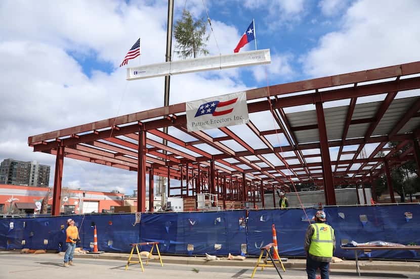 A beam was lifted into place Tuesday at the site of the Mark Cuban Cost Plus Drug Co....