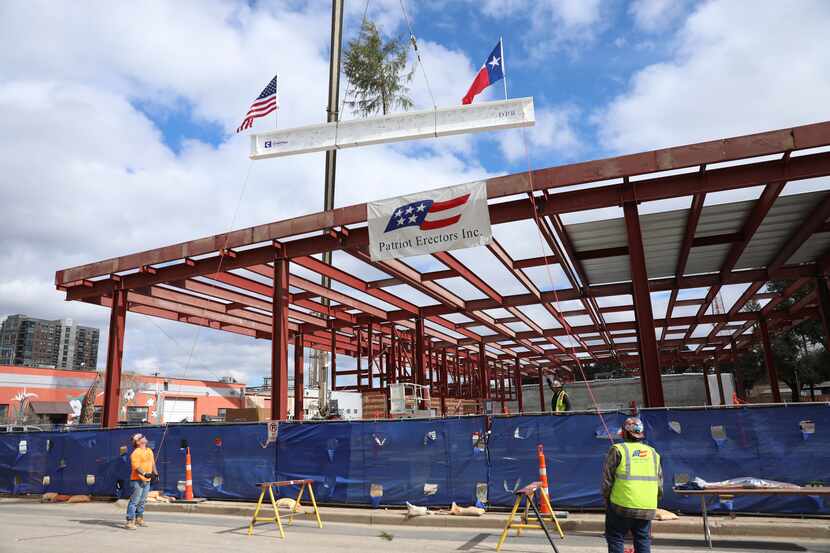 A beam was lifted into place Tuesday at the site of the Mark Cuban Cost Plus Drug Co....