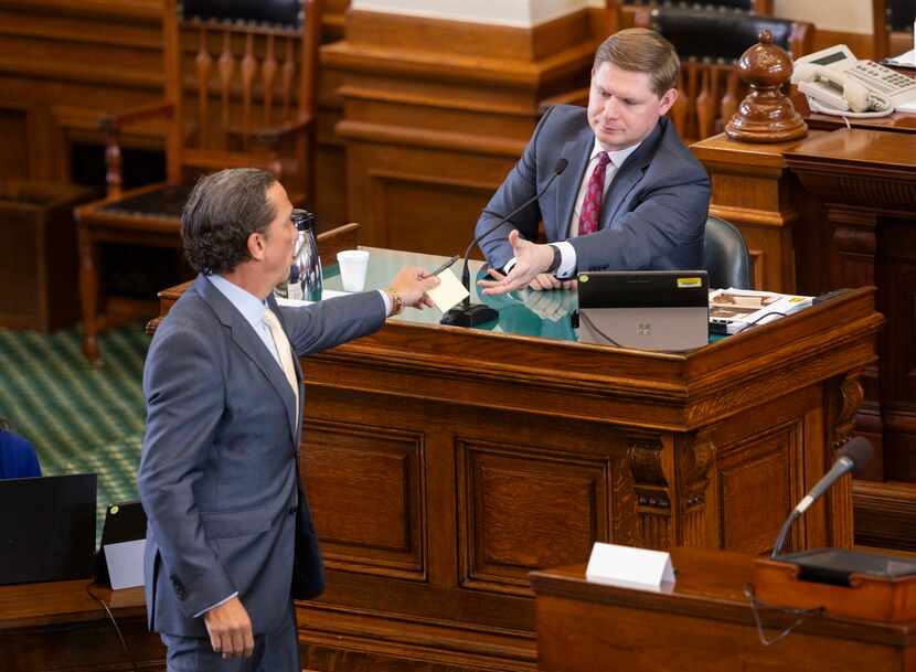 (From left) Tony Buzbee, attorney for Texas  Attorney General Ken Paxton, hands witness...