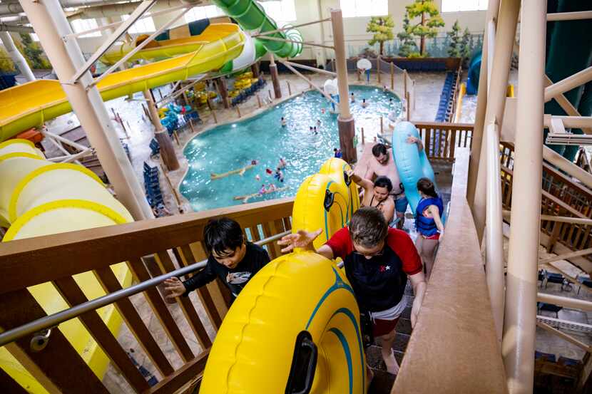 People climb the stairs to ride the slides at Great Wolf Lodge in Grapevine on Thursday,...