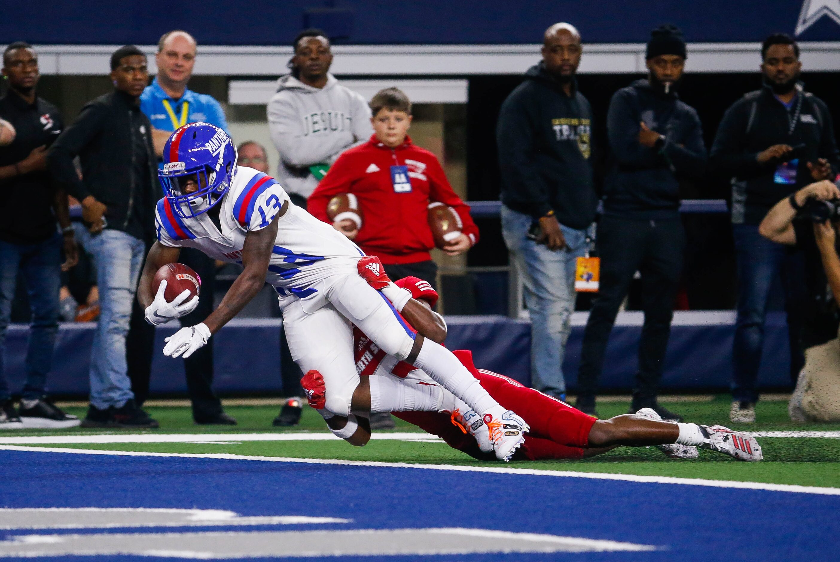 Duncanville's Roderick Daniels (13) scores a touchdown while being tackled by North Shore's...