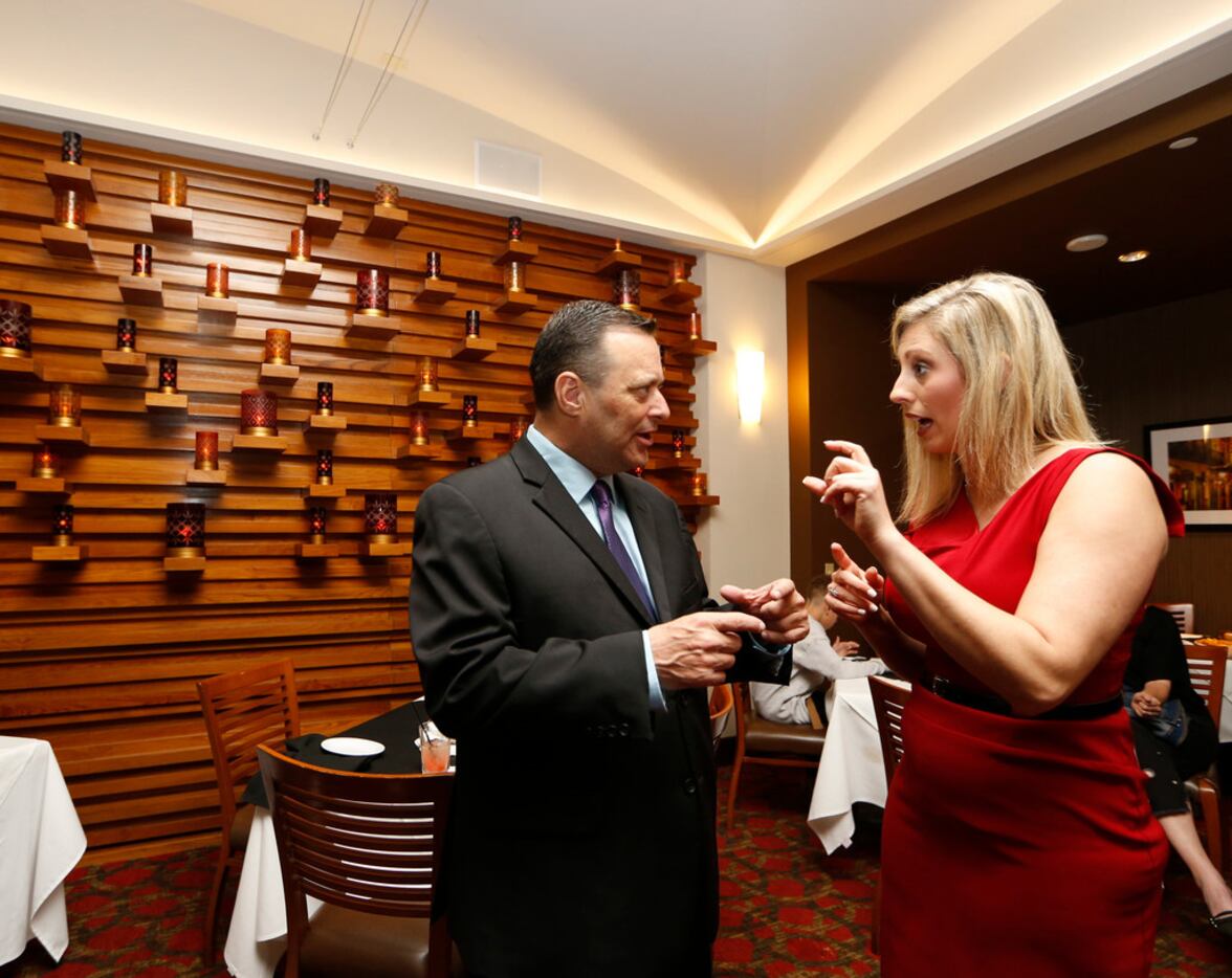 Ericka Downey (right) talks to Billy Gillispie during a Final Four party for coaches at...