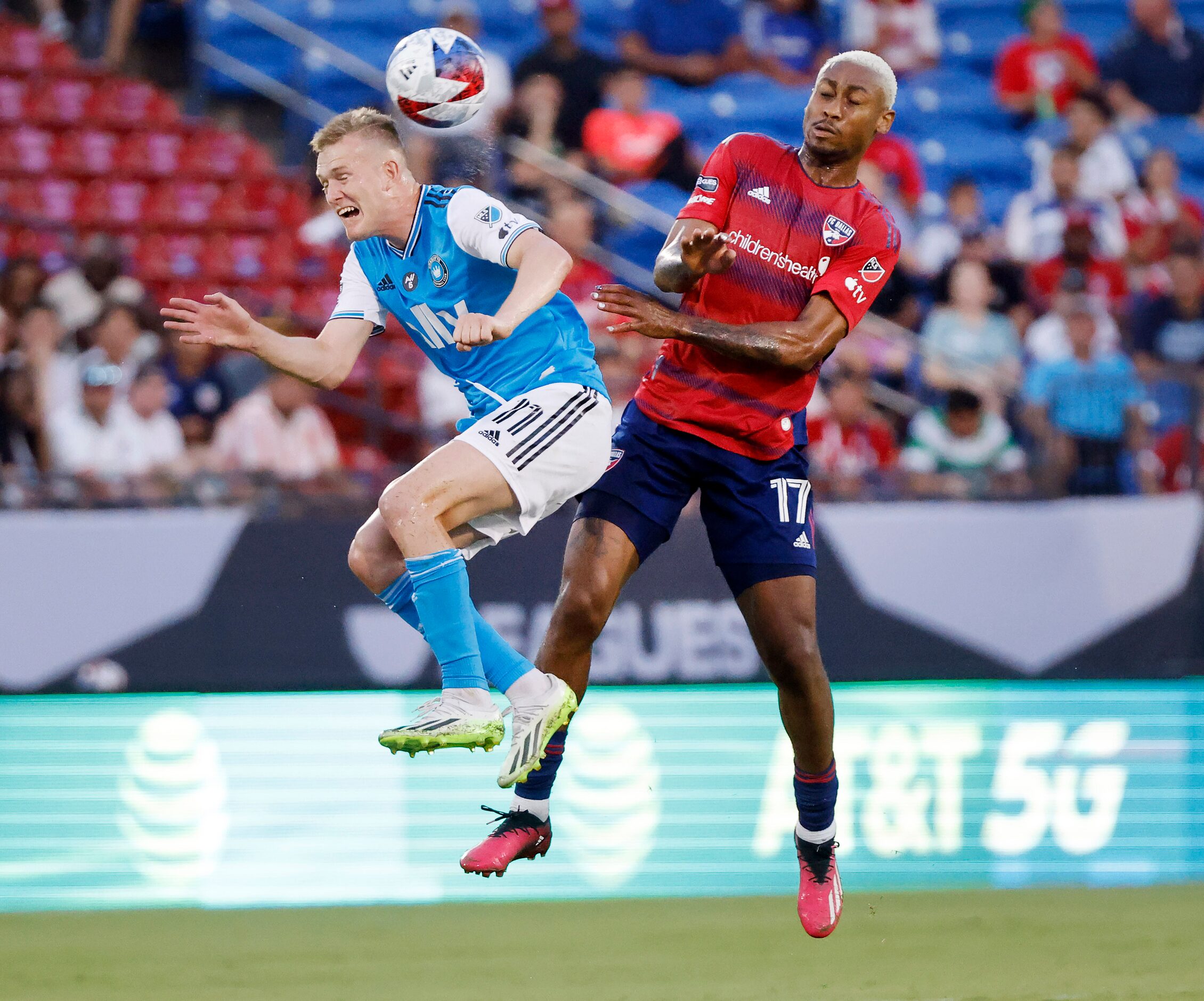 Charlotte FC forward Karol Świderski (11) goes flying as he tries to secure the ball against...