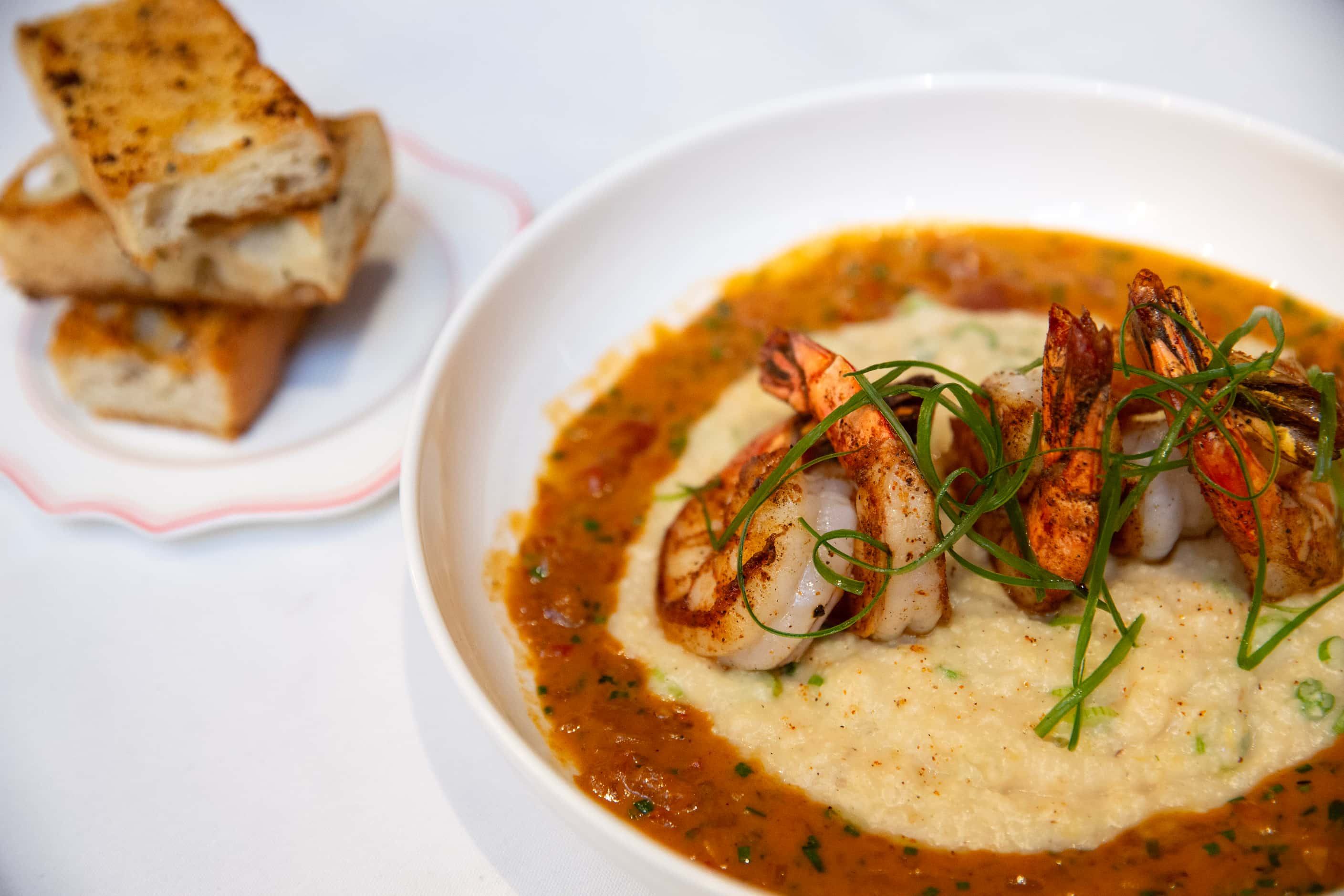 Barbeque shrimp with white cheddar grits is a Louisiana-inspired dish at French bistro...
