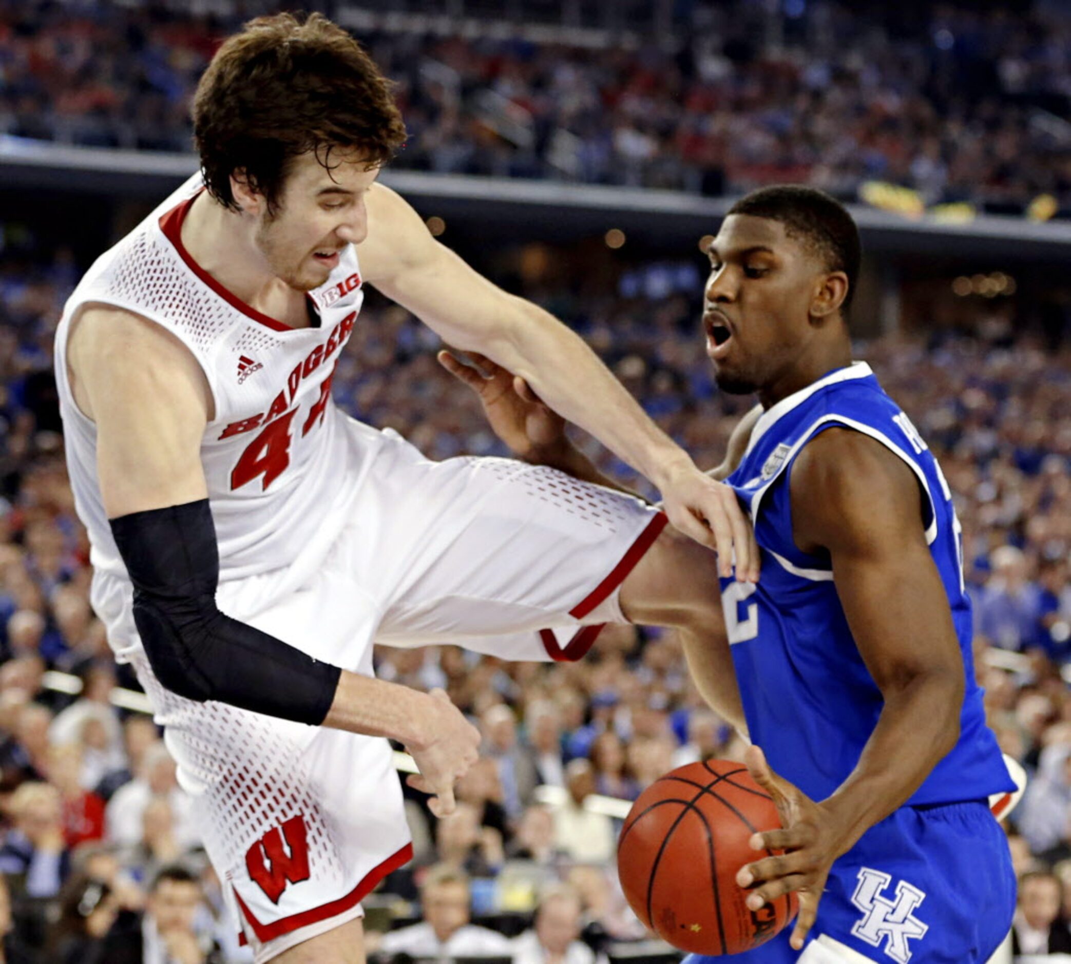 Wisconsin Badgers forward Frank Kaminsky (44) tries to force the ball out of bounds off of...