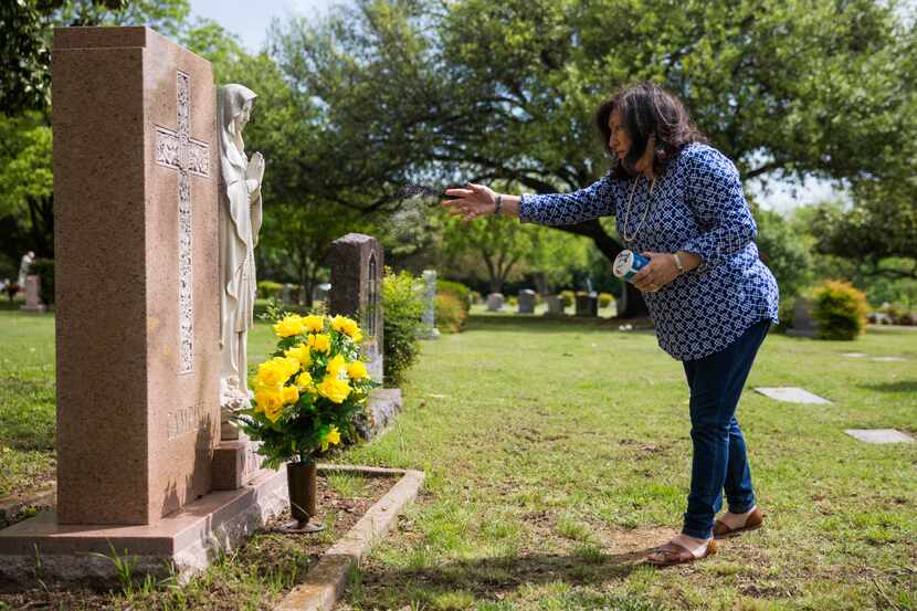 Mary Frances Archer tossed blessed salt on the final resting place of her father, Frank...