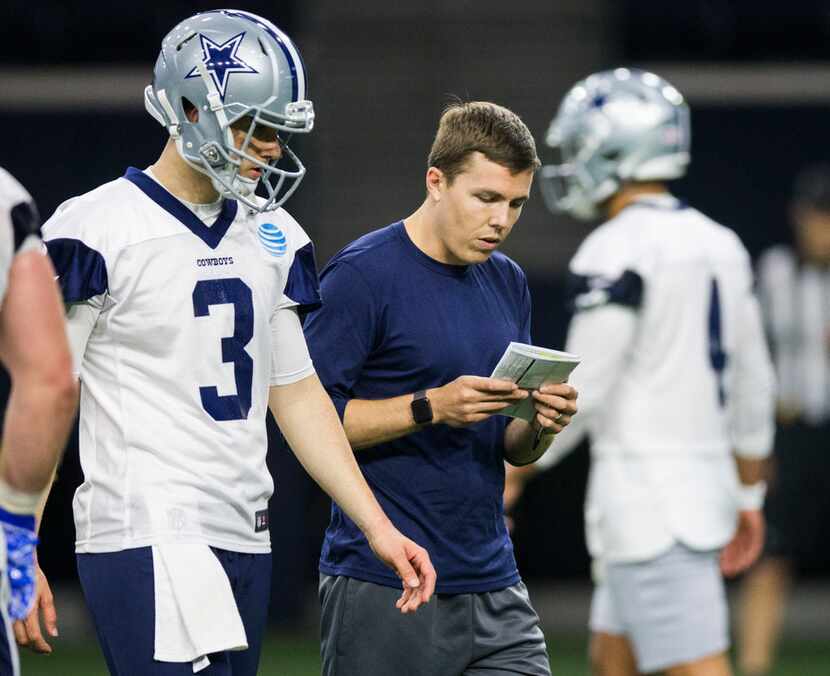 Dallas Cowboys offensive coordinator Kellen Moore talks to quarterback Mike White (3) during...