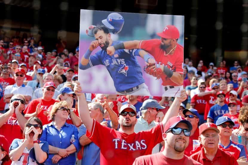 Texas fans jeer Toronto Blue Jays right fielder Jose Bautista -- one fan held up a copy of...