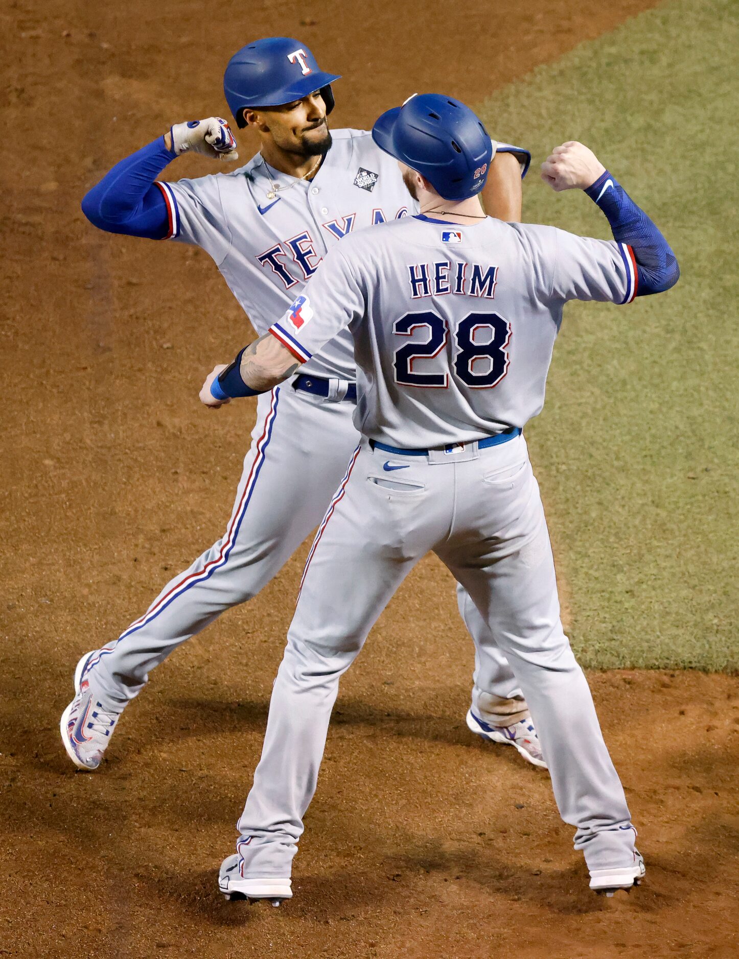 Texas Rangers second baseman Marcus Semien celebrates with Jonah Heim after hitting a...