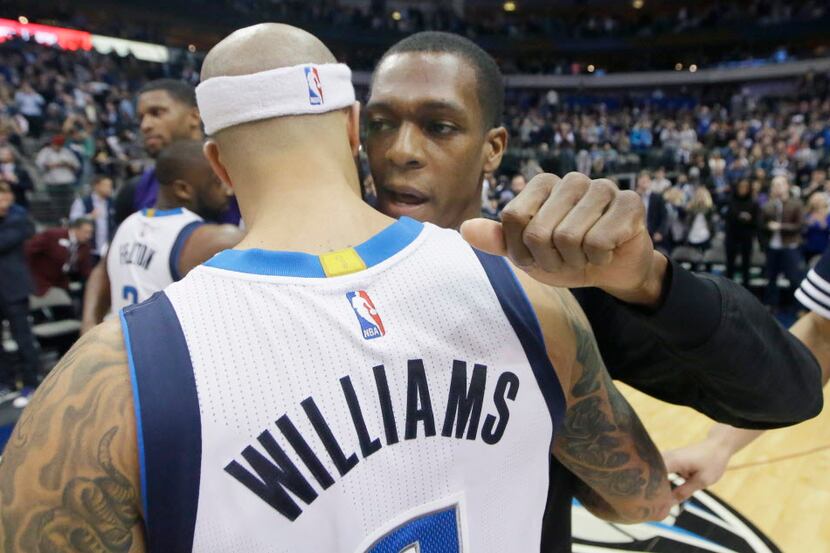 Dallas Mavericks guard Deron Williams gets a hug from Sacramento Kings guard Rajon Rondo...