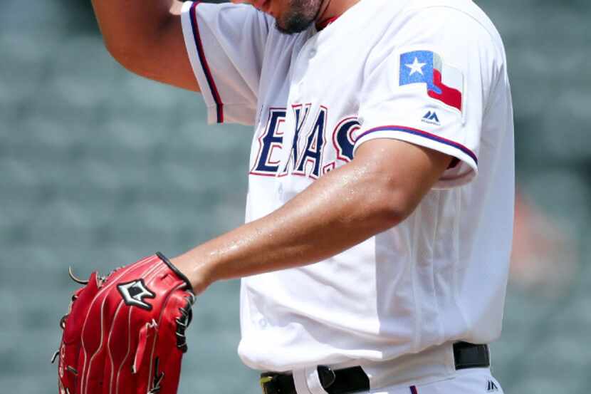 ARLINGTON, TX - JULY 09:  Yu Darvish #11 of the Texas Rangers reacts while being pulled from...