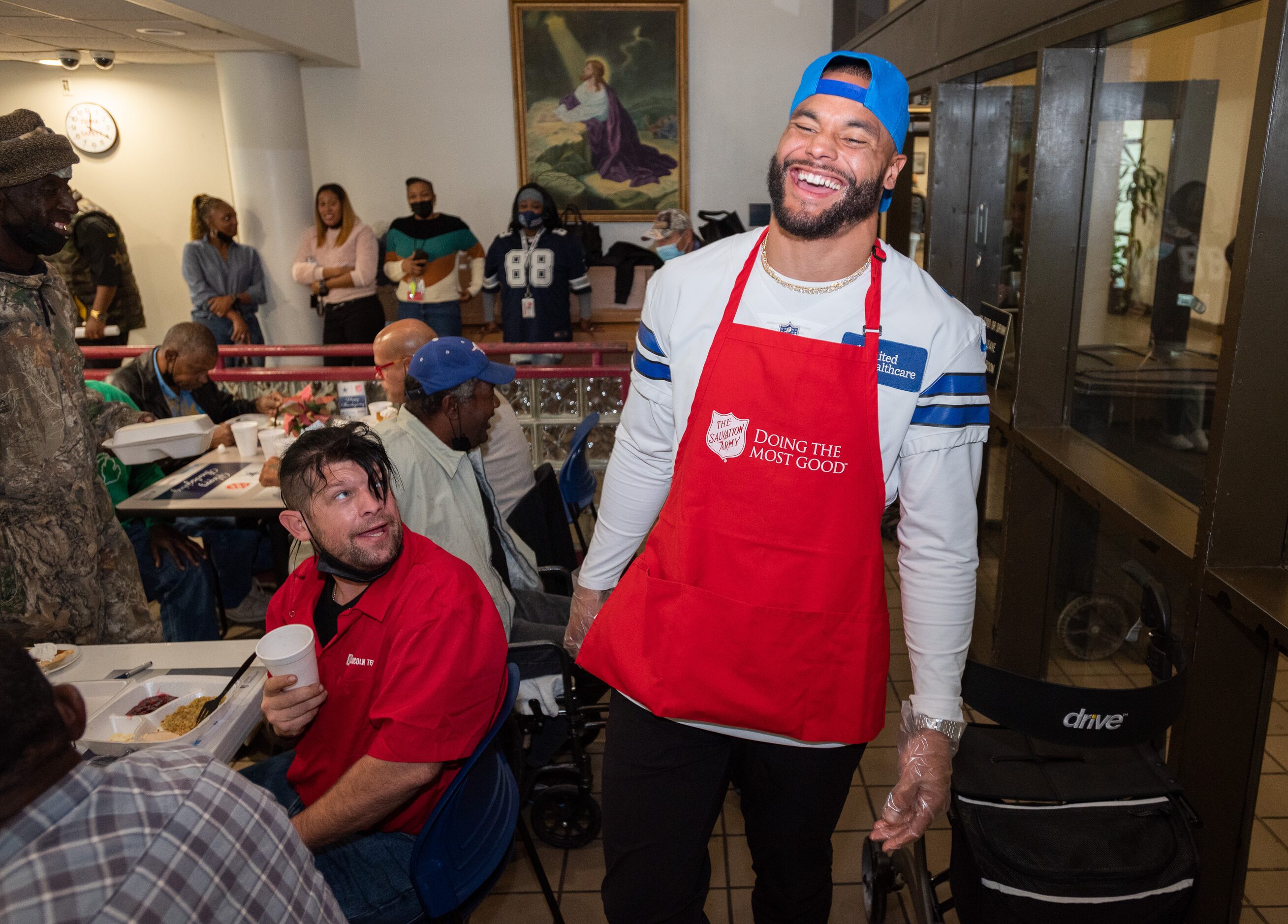 Dallas Cowboys starting quarterback Dak Prescott reacts with laughter as he spoke to a group...