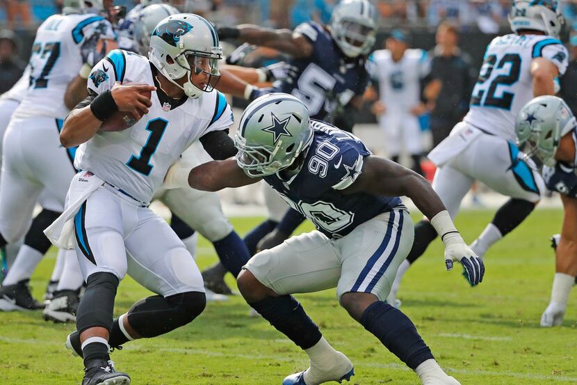 Dallas Cowboys defensive end Demarcus Lawrence (90) makes the tackle on Carolina Panthers...
