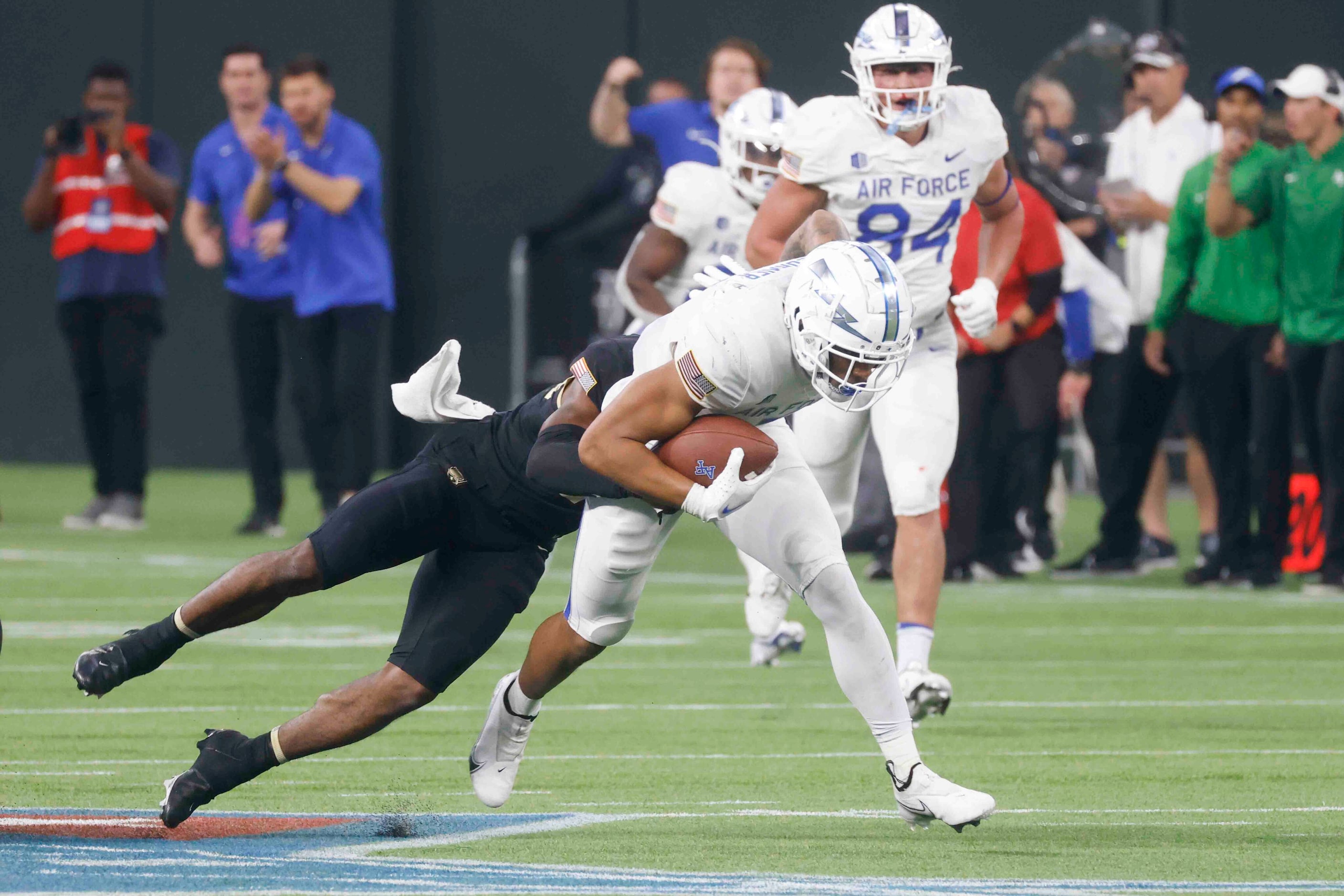 Air Force wide receiver David Cormier (7), right, gets tackled by Army defensive back...